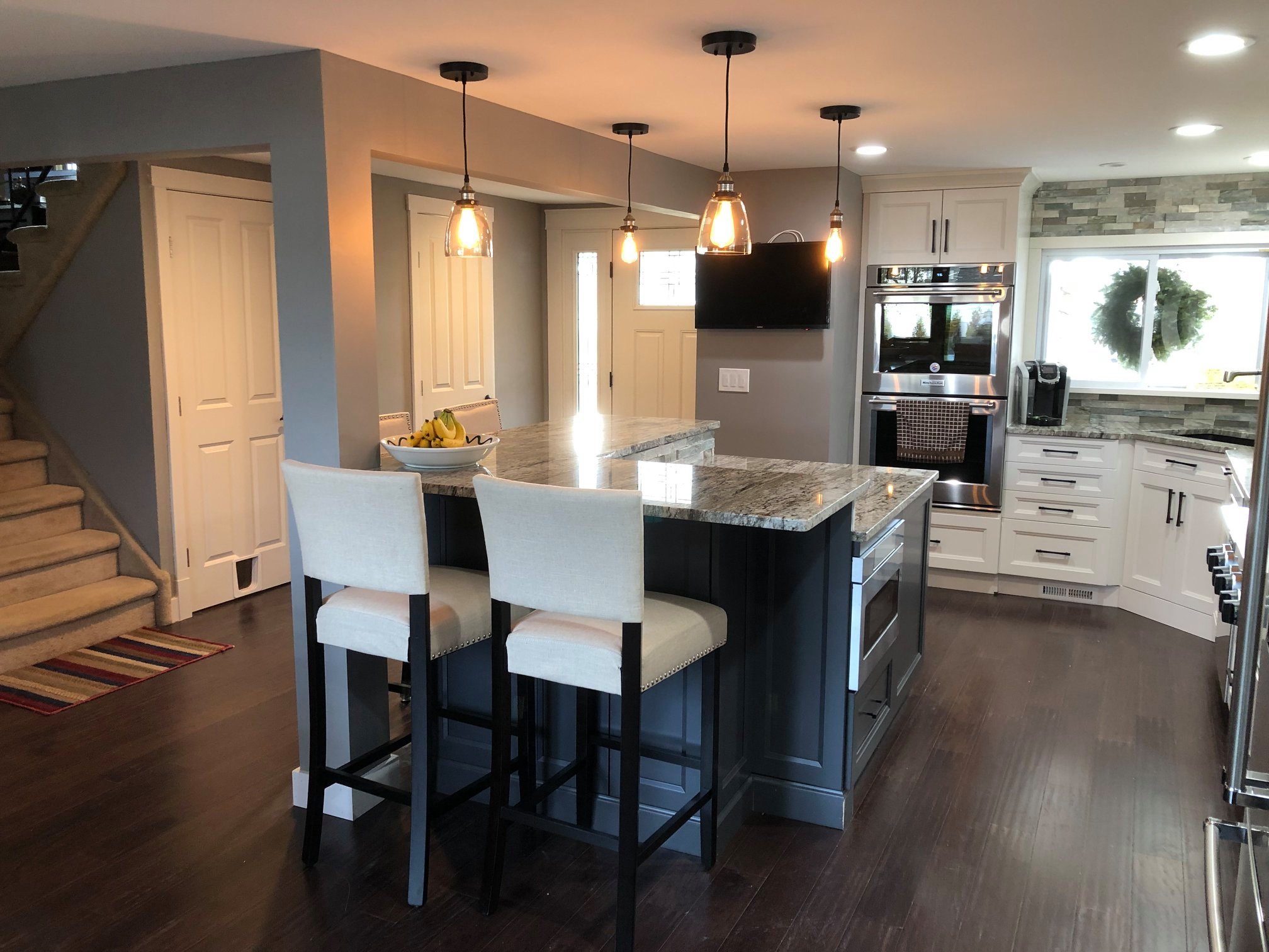 Complete kitchen remodel in Arlington Virginia home by Optima Kitchen and Bath, showing new island, cabinets, and appliances