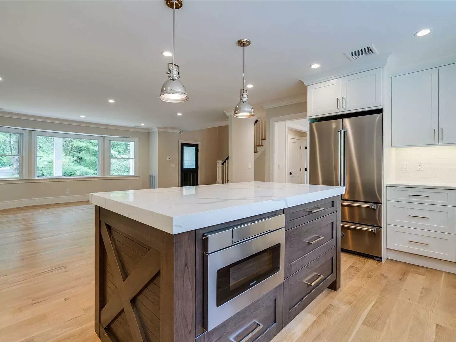 Completed kitchen remodel on Harold Record St - white shaker cabinets and quartz countertops
