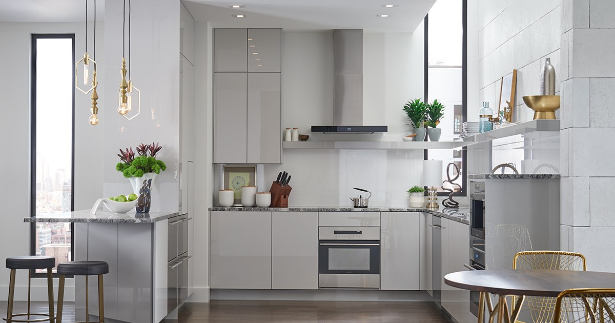 Modern kitchen renovation in Arlington VA by Optima Kitchen and Bath featuring white shaker cabinets, quartz countertops, and subway tile backsplash